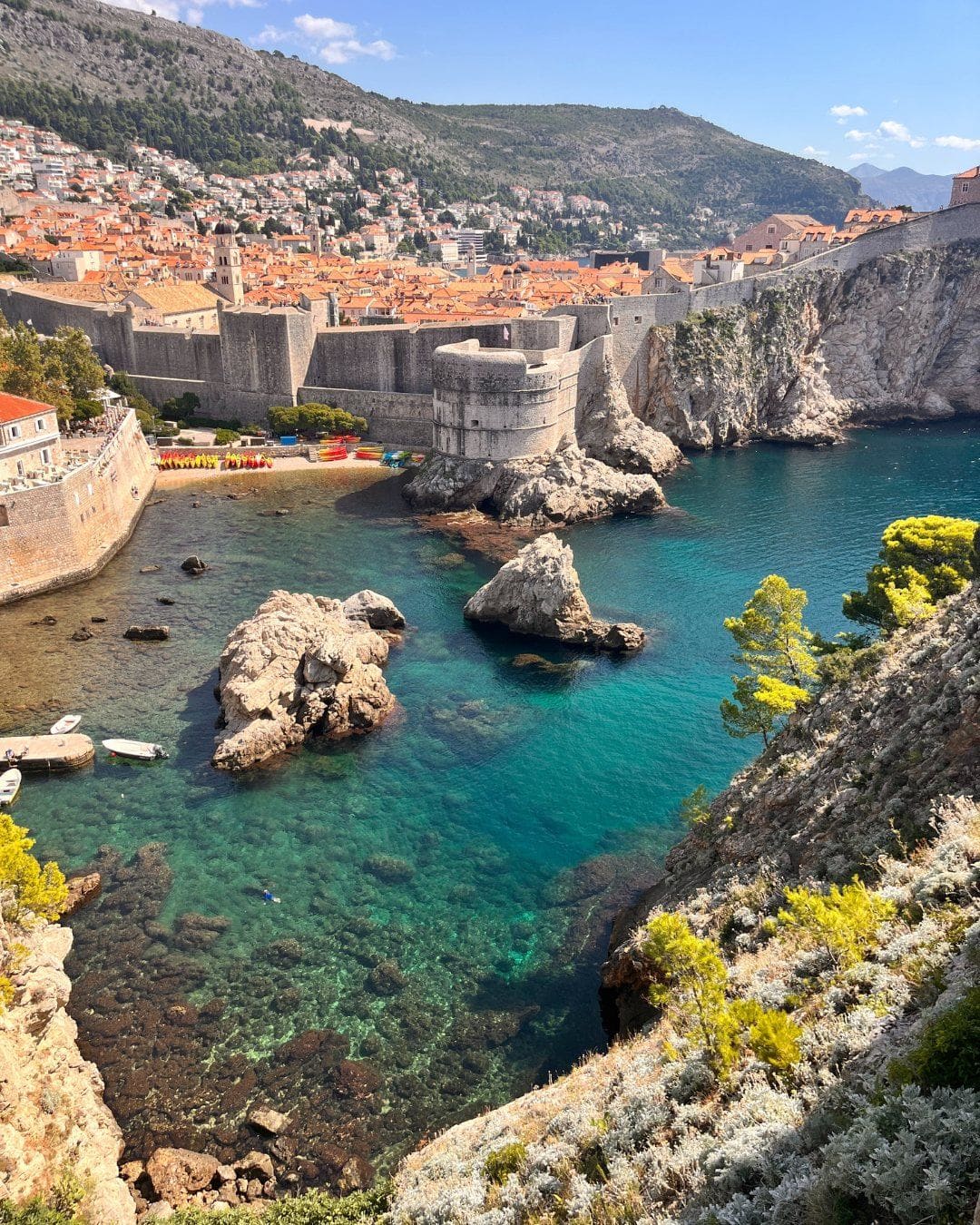 Dubrovnik's old town walls above a turquoise cove