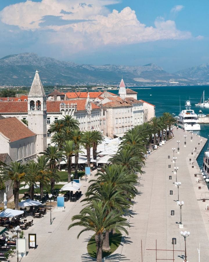 Trogir's palm-lined waterfront promenade beside the old town